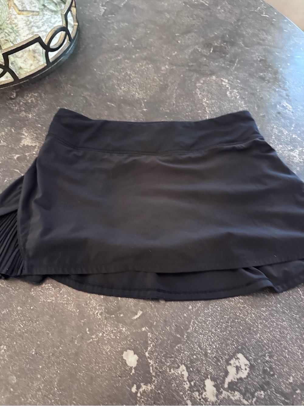 Lululemon Play Off The Pleats Skirt in black featuring a pleated side detail